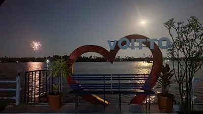 a bench in front of the water with a fireworks at Voitto Vista in Cochin