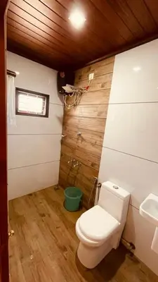 a bathroom with a toilet and a sink at Voitto Vista in Cochin