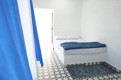 a small bedroom with a bed and a mirror at Voitto Vista in Cochin