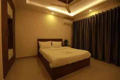 a bedroom with a bed and a window with curtains at Platinum Apartments in Chewarra
