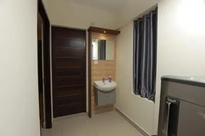 a bathroom with a sink and a toilet and a door at Platinum Apartments in Chewarra