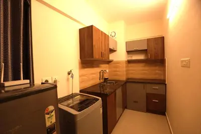 a small kitchen with a sink and a refrigerator at Platinum Apartments in Chewarra