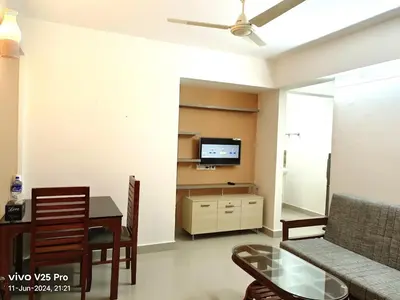 a living room with a couch and a table and a tv at Platinum Apartments in Chewarra