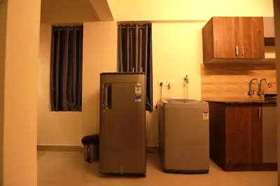 a kitchen with two refrigerators in a room at Platinum Apartments in Chewarra