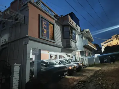 a group of cars parked in front of a building at Sri Sai Residency Ooty in Ooty