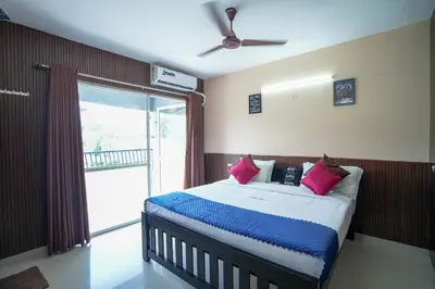a bedroom with a bed and a large window at Stella Marries Airpot Lounge in Nedumbassery