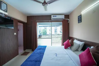 a bedroom with a bed and a large window at Stella Marries Airpot Lounge in Nedumbassery