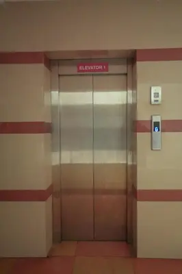an elevator in a building with a sign on it at Stella Marries Airpot Lounge in Nedumbassery