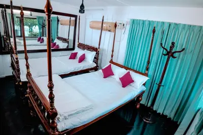 a bedroom with two beds and a mirror at Kadal boutique beach stay in Green Island