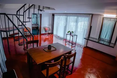 a room with a table and chairs and a staircase at Kadal boutique beach stay in Green Island