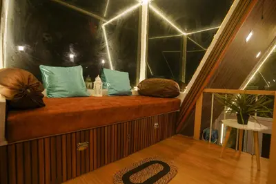 a room with a bench with pillows on a boat at Casa de Selas - A Chalet Stay in Coonoor