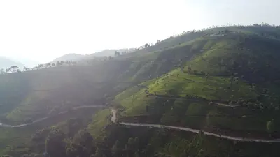 an aerial view of a mountain with a road on it at Casa de Selas - A Chalet Stay in Coonoor