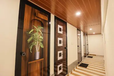 a hallway with a door and a potted plant at Velvet Oasis Cottages in Vythiri