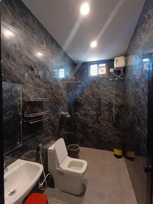 a bathroom with a toilet and a sink at Velvet Oasis Cottages in Vythiri