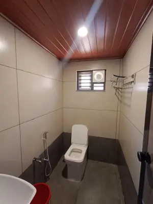 a small bathroom with a toilet and a sink at Velvet Oasis Cottages in Vythiri