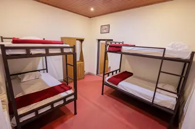 a room with three bunk beds in a room at Velvet Oasis Cottages in Vythiri