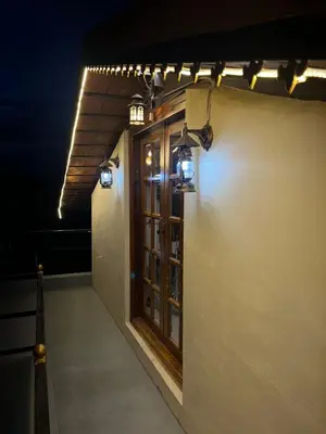 a room with a window and lights on the side of a building at Aaloka stay in Mysore