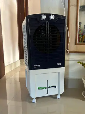 a television sitting on a stand on a floor at Sogni D oro in Mysore