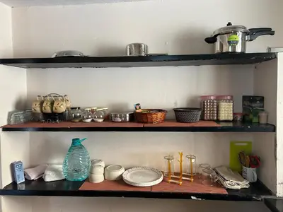 a shelf with dishes and other items on it at Sogni D oro in Mysore