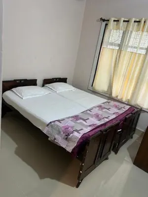 a small bed in a room with a window at Sogni D oro in Mysore