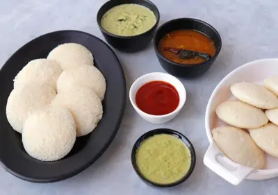 a table with a plate of food with biscuits and dipping sauces at Silver Dale Tea Estate Bungalow Ooty by VOYE HOMES in Ooty