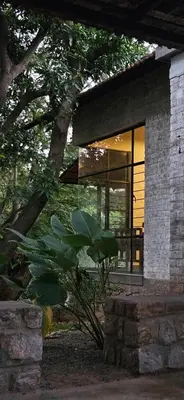 a house with a window and a plant in front of it at Pannadikadu Homestay in Sethumadai