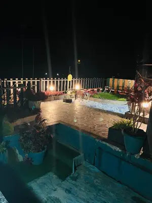 a swimming pool in a yard at night at Tea vista holiday home in Kalpetta