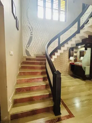 a stairway with a blue and white stair case at Stay Easy - Potta, Athirapally Road in Kizhake Chālakudi