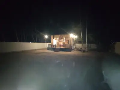 a small building at night with lights on it at Katadi beach home in Thanniyam