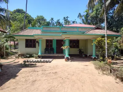 a small house with a blue at Katadi beach homestay in Trichūr