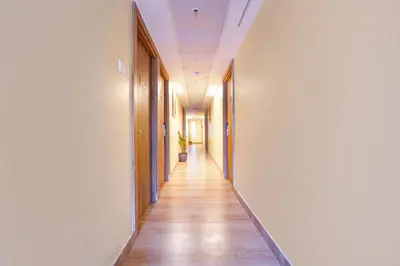 a hallway of an office building with wooden floors and ceilings at FabHotel INK - Nr Coimbatore North Railway Station in Coimbatore