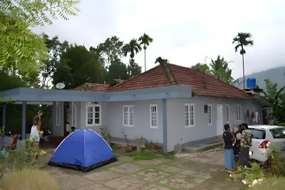 a blue tent in front of a house at VIHA The Heaven in Meppādi