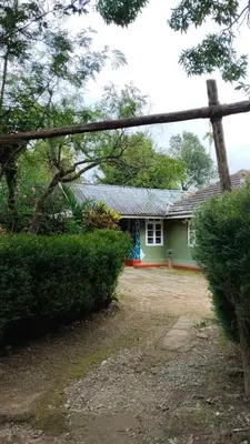a house with a green and red house at VIHA The Heaven in Meppādi