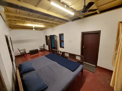 a bedroom with a large bed in a room at VIHA The Heaven in Meppādi