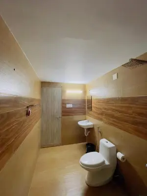 a bathroom with a toilet and a sink at RiverSoul Villa in North Paravur