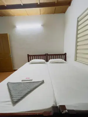 a white bed with a keyboard on it in a room at RiverSoul Villa in North Paravur