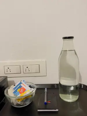 a bottle of water and a bowl on a counter at RiverSoul Villa in North Paravur