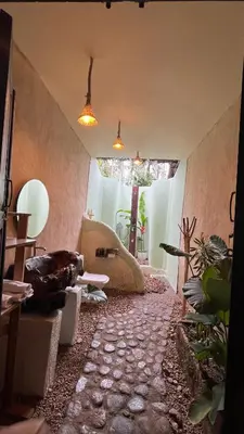 a living room with a couch and some plants at HeavensAway in Marayoor
