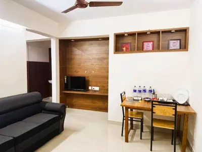a living room with a couch and a table at Classic Cochin Airport Hotel in Nedumbassery