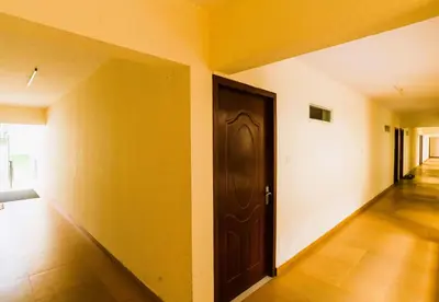 an empty room with a door and a hallway at Classic Cochin Airport Hotel in Nedumbassery