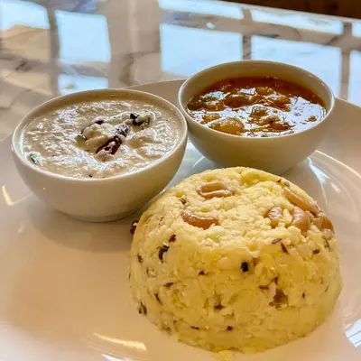 a plate with two bowls of soup and a cookie at Jade Pearl Kotagiri in Kotagiri