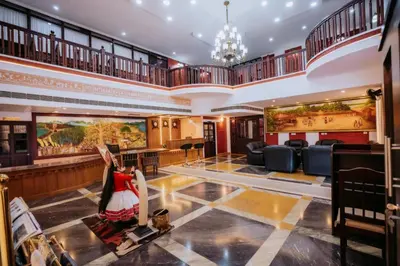 a large lobby with a woman in a dress on the floor at Nirmallyam Residency Hotel in Edappāl