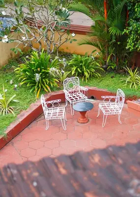 a group of chairs and a table and a fire hydrant at Bough'n Villa 1B - Balcony room in Kozhikode