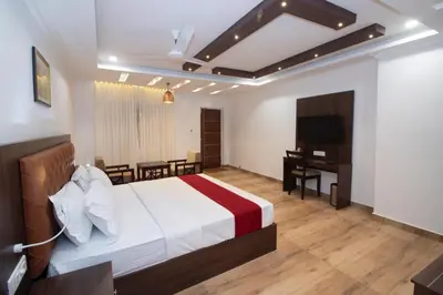 a hotel room with a bed and a desk at Cloud Five in Munnar