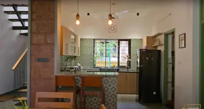 a kitchen with a refrigerator and a counter top at Solace Villa 2BHK AC in Kakkayam
