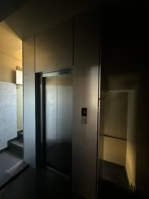 an elevator in a building with its door open at Bloomax Residency in Malappuram