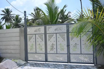 a gate in a fence with palm trees behind it at Bhuvi farm & homestay in Channapatna