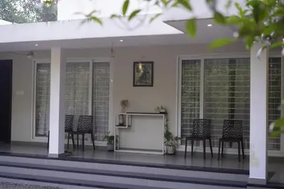 a screened in porch with chairs and a screen at Nutmeg Haven Plantation stay in Chewarra