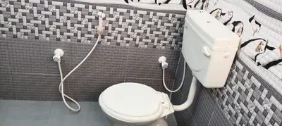 a bathroom with a white toilet in a room at Sri Annapoorna Luxury Apartment - Serviced Apartment in Coimbatore
