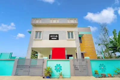 a house with a gate in front of it at Super Hotel O Ganapathy Athipalayam Pirivu Road in Coimbatore